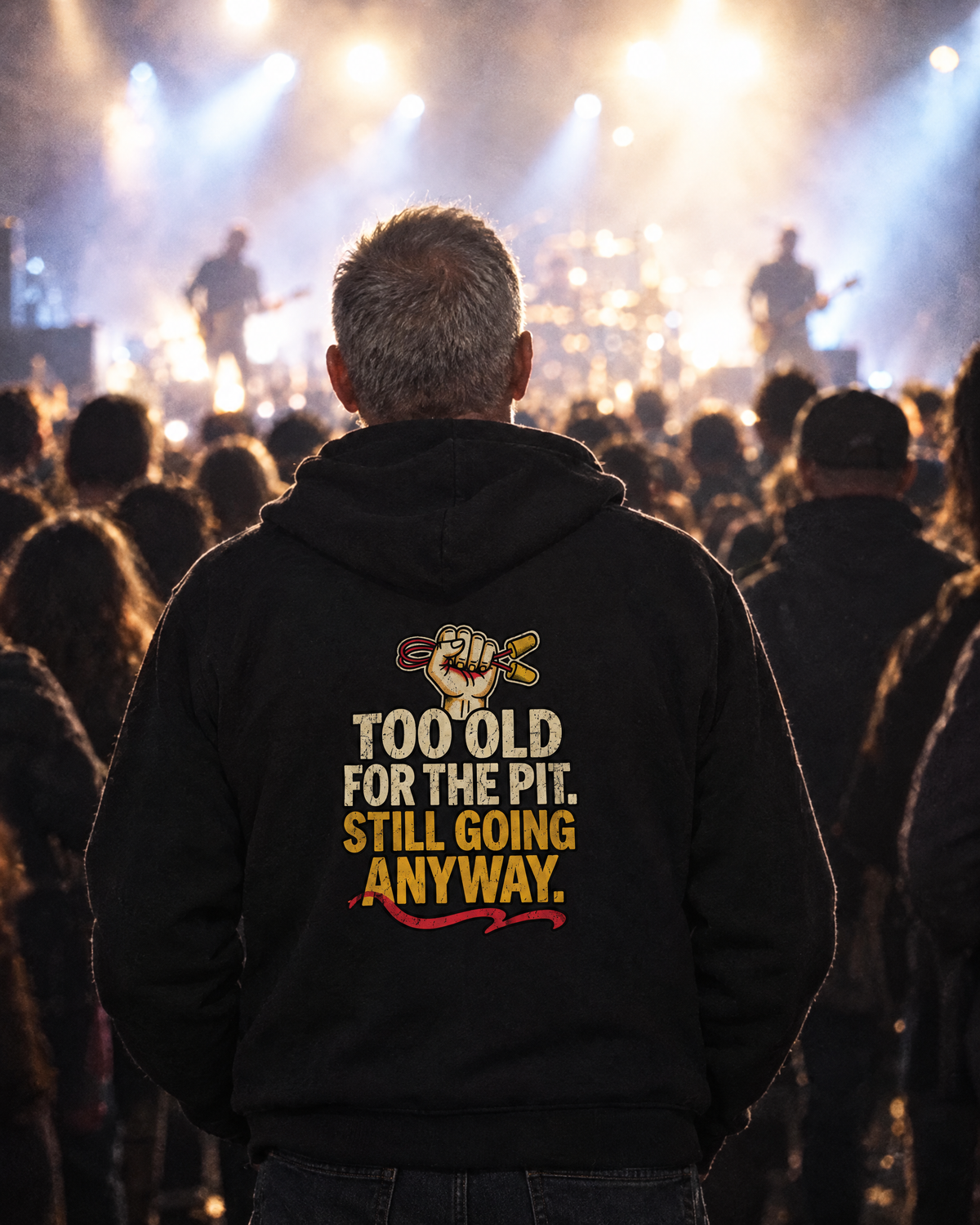 Man at the back of a concert crowd wearing the Too Old for the Pit hoodie